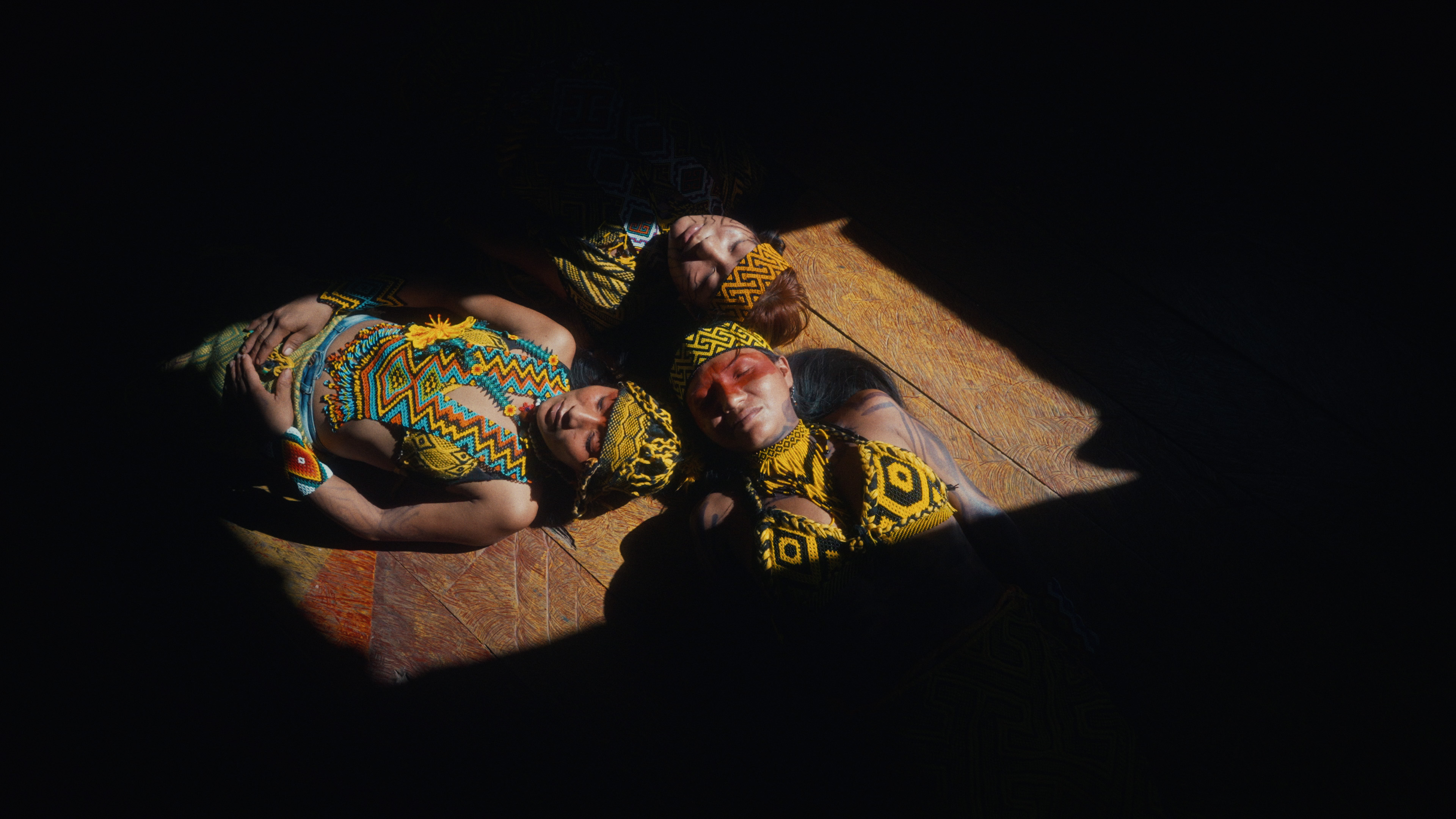 Three Huni Kuin women resting in a shaft of light